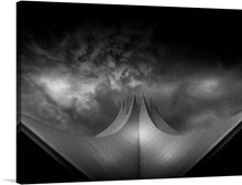  “Berlin Curved Architecture” is a stunning black and white print by Lobo Studio Hamburg that captures the essence of the city’s modern architecture. The dramatic curves and sharp angles of the building are contrasted by the moody sky, creating a striking image that would make a great addition to any art collection. 