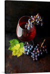 This exquisite artwork captures the essence of fine wine in a single frame. The macro view of a wine glass brimming with rich, red wine is a testament to the artistry of winemaking. The bunch of grapes, each berry kissed by nature’s palette of colors, rests gracefully on the glass’s edge, adding a touch of elegance to the composition.