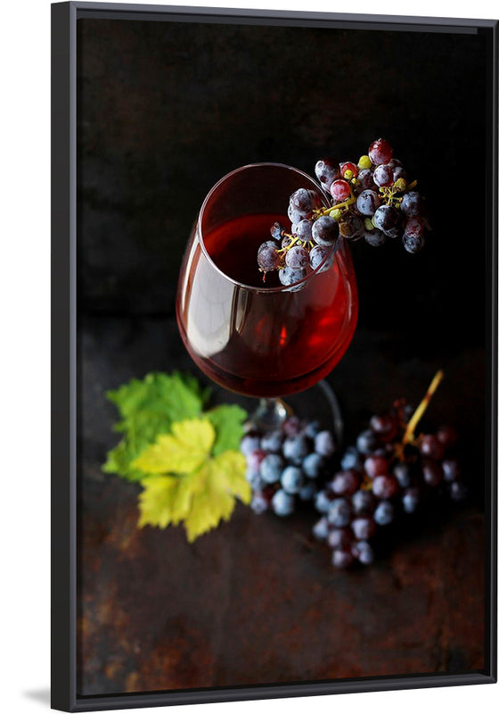 "Macro view of a wine glass containing alcoholic wine with a bunch of grapes."