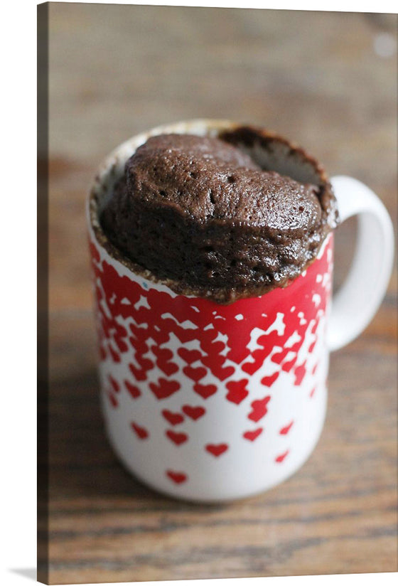 The rich, dark chocolate cake contrasts beautifully with the bright red mug, making this print a statement piece that is sure to catch the eye. The image is a photo-realistic depiction of a chocolate mug cake in a red and white heart-patterned mug.