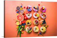  “Fruit Cakes” is a limited edition print that promises to breathe life and color into any space. The artwork features an array of decorated donuts interspersed with fresh fruits on a coral background. Each donut is uniquely adorned with toppings like flowers, fruits (including berries), and sprinkles creating visually striking patterns.