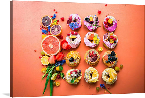 “Fruit Cakes” is a limited edition print that promises to breathe life and color into any space. The artwork features an array of decorated donuts interspersed with fresh fruits on a coral background. Each donut is uniquely adorned with toppings like flowers, fruits (including berries), and sprinkles creating visually striking patterns.