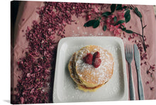  “Pancakes with Berries” is a captivating print that captures the essence of a leisurely breakfast. The artwork showcases a stack of golden pancakes topped with succulent red berries and a dusting of powdered sugar. The plate is set against a backdrop of delicate pink blossoms scattered gracefully around it, creating a symphony of textures and colors.