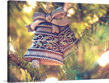  This beautiful print of a Christmas ornament shaped like two bells hanging from a tree is sure to add a touch of elegance to your holiday decor. The intricate details and warm colors make this piece a perfect addition to any home. The image is a realistic photograph of a Christmas ornament made of metal with intricate details. 