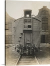 This striking black-and-white photograph of a US Army boxcar built by the Pullman Company in October 1917 is a powerful reminder of America's military history. The car is sitting on a track in front of a brick building. The car is made of wood and has a ladder on the back.