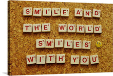  This artwork is a charming celebration of positivity, meticulously crafted using Scrabble tiles to spell out the uplifting message: “SMILE AND THE WORLD SMILES WITH YOU”. The rich, wooden texture of the tiles and the bold red letters contrast beautifully against the textured, cork background. A whimsical touch is added with a solitary smiley face pin, strategically placed at the end of the phrase. 
