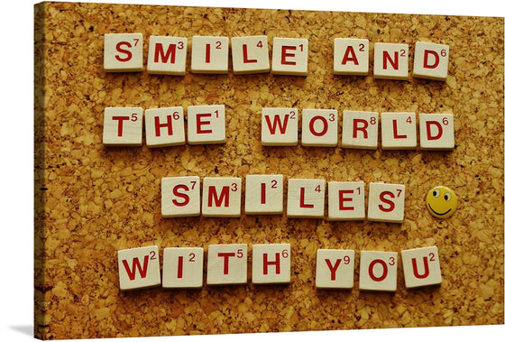 This artwork is a charming celebration of positivity, meticulously crafted using Scrabble tiles to spell out the uplifting message: “SMILE AND THE WORLD SMILES WITH YOU”. The rich, wooden texture of the tiles and the bold red letters contrast beautifully against the textured, cork background. A whimsical touch is added with a solitary smiley face pin, strategically placed at the end of the phrase. 