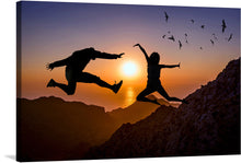  “Jump With Joy” is a mesmerizing artwork that captures the exhilarating moment of two silhouetted figures leaping against the backdrop of a breathtaking sunset. The golden hues of the setting sun cast a warm glow, illuminating the intricate details of the rocky terrain and reflecting off tranquil waters below. 