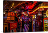 Step into the electrifying atmosphere of our “Gaming Arcade” print, where nostalgia and excitement merge in a visual symphony of color and light. Every corner is adorned with iconic brands and memorabilia, igniting the thrill of yesteryears. The checkered floor, bathed in the neon glow, guides you through an eclectic mix of classic arcade games and vintage décor. 