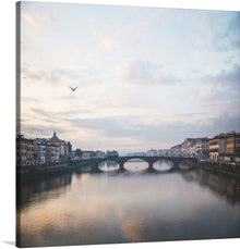  This beautiful photograph captures the iconic Ponte Vecchio bridge in Florence, Italy. The bridge is one of the most popular tourist destinations in the world, and it is known for its unique shops and beautiful views of the Arno River.