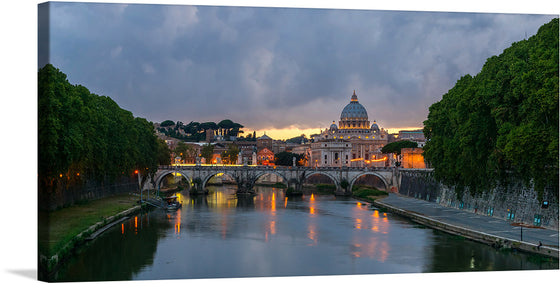 “Sant’Angelo Bridge, Dusk, Rome, Italy” by Jebulon is a stunning print that captures the essence of Rome’s eternal charm. The image features Sant’Angelo Bridge spanning across Tiber River during dusk in Rome, Italy. St. Peter’s Basilica is prominently featured in the background; its illuminated dome contrasts beautifully against a sky transitioning from day to night. 