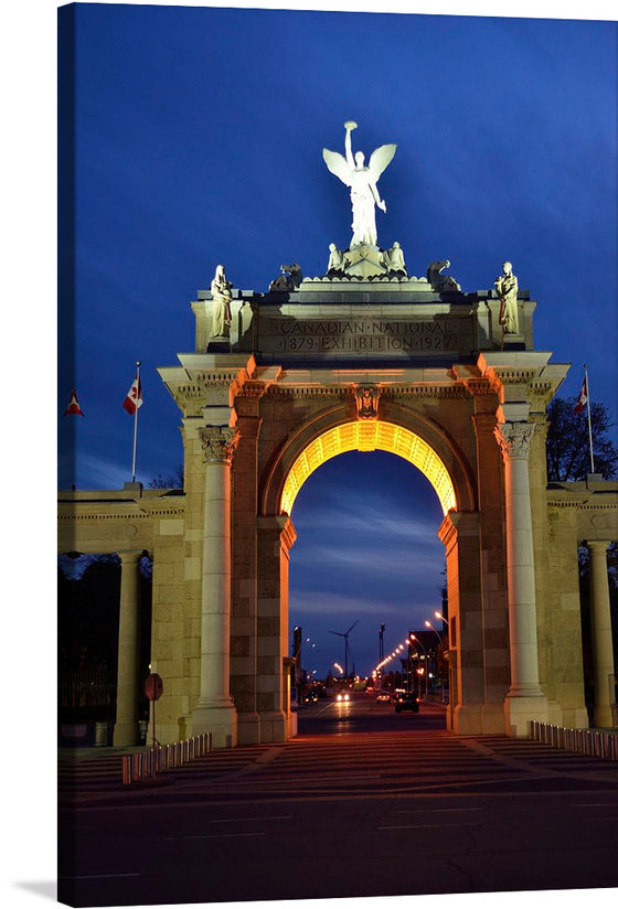 This print captures the majestic Princes’ Gates, an iconic entrance to Exhibition Place in Toronto, Canada. Bathed in the soft glow of twilight, the grand archway stands as a testament to architectural splendor and historical significance. Atop the structure, a triumphant angelic statue spreads its wings wide against the deepening blue sky, embodying a sense of freedom and victory.