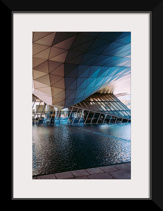 "Low Angle Shot Of A Futuristic Building Design With An Outdoor Pond"