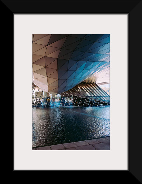 "Low Angle Shot Of A Futuristic Building Design With An Outdoor Pond"