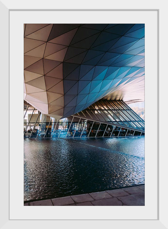 "Low Angle Shot Of A Futuristic Building Design With An Outdoor Pond"