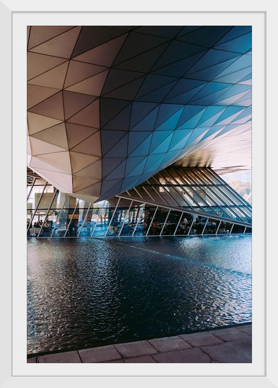 "Low Angle Shot Of A Futuristic Building Design With An Outdoor Pond"