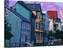  Immerse yourself in the enchanting allure of Reykjavik with this exquisite print, “Buildings In Iceland, Reykjavik.” Every brushstroke captures the city’s architectural charm and vibrant atmosphere. The artwork features a row of iconic Icelandic buildings, each boasting distinct designs and a palette of colors as diverse and harmonious as the city itself. The sky, painted with passionate strokes of majestic purples and pinks, casts an ethereal glow that breathes life into the structures.