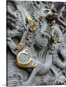  This print showcases a close-up of a dragon sculpture, exuding an aura of majesty and power. The dragon, crafted from gray stone, is adorned with gold accents on its body, claws, and whiskers, adding a touch of elegance to its formidable form. 