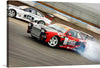 Experience the thrill of professional racing with this stunning print. The artwork vividly captures two race cars in fierce competition, their speed and power palpable. The lead car, a vibrant red adorned with contrasting sponsor logos, is caught mid-drift, its tires screeching against the asphalt as smoke billows behind. Hot on its tail is a sleek white competitor, its determination evident. 