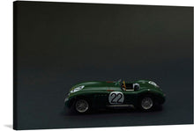  Immerse yourself in the world of classic racing with this exquisite print. The artwork features a meticulously detailed model of a green racing car, marked with the iconic “22”. Set against a dark backdrop, every curve and contour is accentuated, evoking the thrilling atmosphere of historic races. 