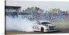 “White Race Car Burnout”: Unleash the thrill of speed and power with our exclusive art print! This masterpiece captures a pivotal moment of adrenaline, as a sleek white race car, adorned with vibrant decals, executes a perfect burnout. The thick plumes of smoke encapsulate the vehicle, creating an ethereal yet intense atmosphere that will ignite the passion of any motorsport enthusiast. 