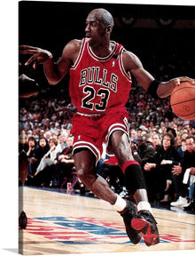  “Jordan elgrafico 1992” is an iconic print that captures the essence of basketball greatness. The artwork features a dynamic pose of one of basketball’s greatest players, Michael Jordan, in mid-action during a game. He is wearing a red Chicago Bulls jersey with the number 23 visible and dribbling an orange basketball. The court floor has visible markings including part of what appears to be the NBA logo. 
