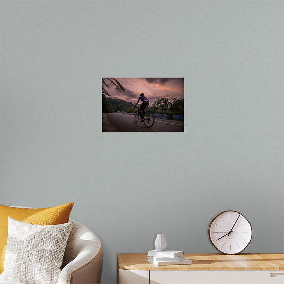 "Male bicycling along a treed road in Ooty"