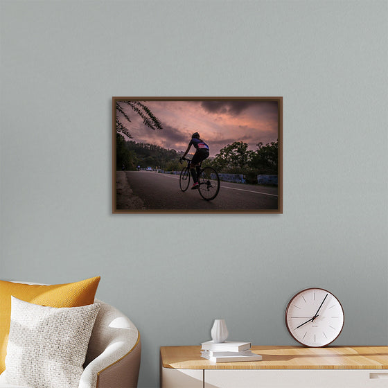 "Male bicycling along a treed road in Ooty"