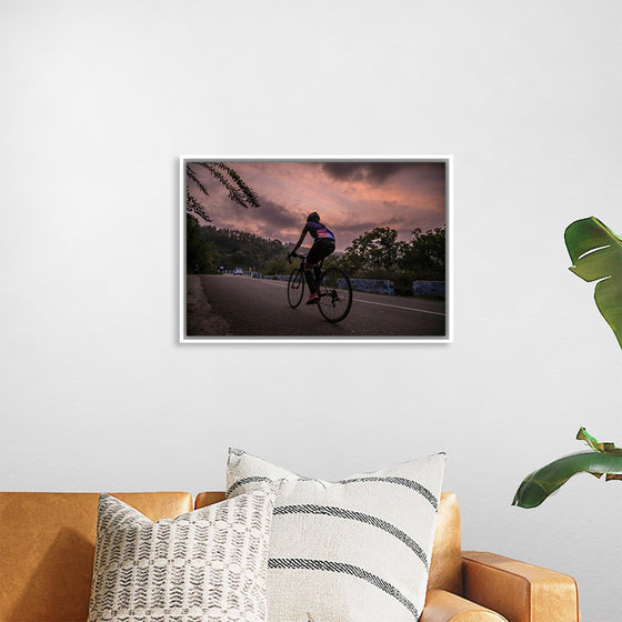 "Male bicycling along a treed road in Ooty"