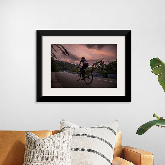 "Male bicycling along a treed road in Ooty"