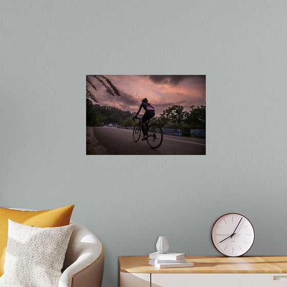 "Male bicycling along a treed road in Ooty"