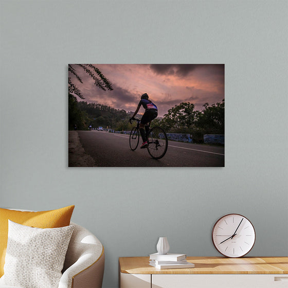 "Male bicycling along a treed road in Ooty"