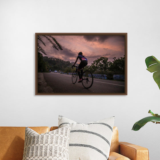 "Male bicycling along a treed road in Ooty"