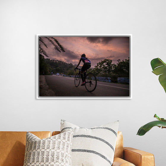 "Male bicycling along a treed road in Ooty"