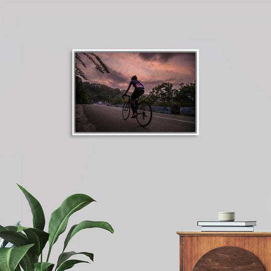 "Male bicycling along a treed road in Ooty"