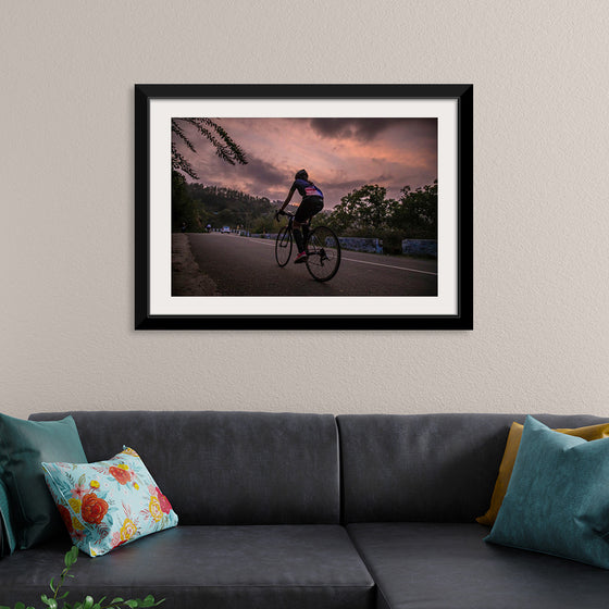 "Male bicycling along a treed road in Ooty"