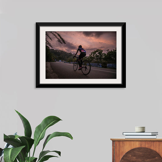 "Male bicycling along a treed road in Ooty"