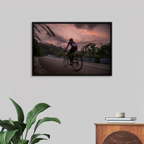 "Male bicycling along a treed road in Ooty"