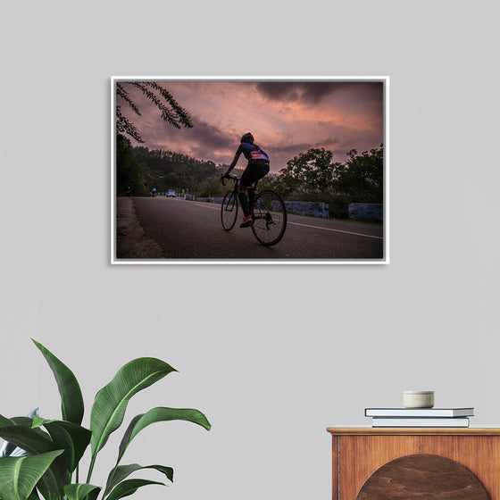 "Male bicycling along a treed road in Ooty"