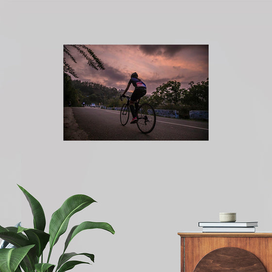 "Male bicycling along a treed road in Ooty"