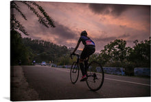  This exquisite print captures the serene beauty of Ooty, with a male cyclist pedaling along a picturesque treed road. The artwork is rich in detail and emotion, encapsulating the tranquil yet invigorating atmosphere of the region. The stunning sunset paints the sky with warm hues of orange and purple, creating a mesmerizing backdrop for the cyclist’s journey.