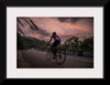 "Male bicycling along a treed road in Ooty"