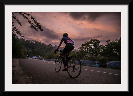 "Male bicycling along a treed road in Ooty"