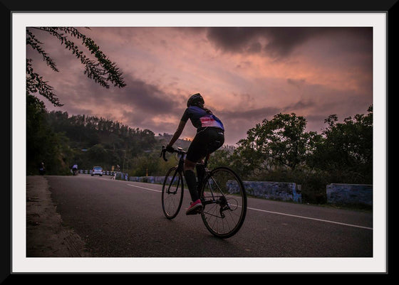 "Male bicycling along a treed road in Ooty"