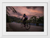 "Male bicycling along a treed road in Ooty"