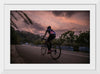 "Male bicycling along a treed road in Ooty"