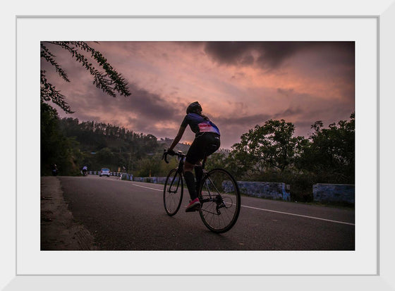 "Male bicycling along a treed road in Ooty"