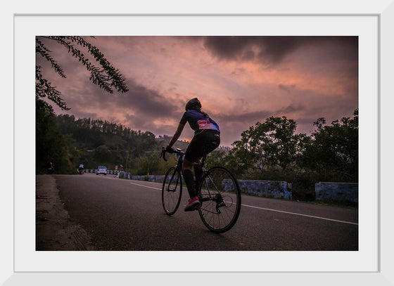 "Male bicycling along a treed road in Ooty"