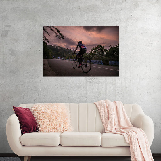 "Male bicycling along a treed road in Ooty"