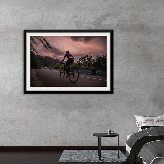 "Male bicycling along a treed road in Ooty"